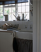 Kitchen sink with watering cans on window sill