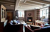 Wood burning stove in corner of living room in Wiltshire