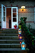 Lit lanterns on steps of Odense home