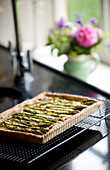 Asparagus quiche cooling on a wire rack