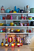 Crockery and homeware on wall sgelving in kitchen of modern Odense family home Denmark