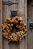 Dried flower Christmas wreath on wooden front door of Cheltenham home Gloucestershire England UK