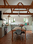 Beamed ceiling in open plan kitchen of Suffolk home England UK