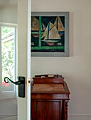 Writing desk and nautical artwork in Suffolk family home England UK