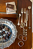 Wooden dice and chocolates with silverware on wood tabletop in Canterbury home England UK