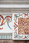 Decorative leaf scrolls on marble fireplace in historic Yeovil Somerset, England, UK