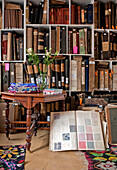 Open book with colour swatches in reference library of London home UK