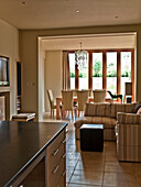 Open plan kitchen dining and sitting area in rural Suffolk home England UK