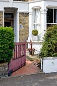 Weathered gate and footpath to London house, England, UK