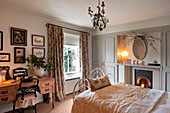 Lit candles in country styled bedroom of Walberton home, West Sussex, England, UK