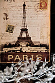 Vintage Eiffel tower souvenir artwork with silver Christmas decorations in Paris apartment, France