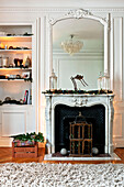 Mirror on fireplace with recessed shelving in Paris apartment, France