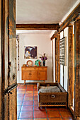 view through doorway to tiled living room with dog basket in Hertfordshire home, England, UK