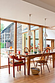 Table and chairs in contemporary Hertfordshire family home, England, UK