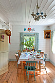 Table set for Easter in white painted wood clad room of Essex home, England, UK