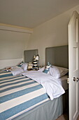 Striped duvets on twin beds in Buckinghamshire home, England, UK