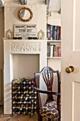 Wine rack in original fireplace of Suffolk farmhouse, England, UK