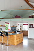 Black barstools with grey worktop in kitchen of contemporary home, Cornwall, England, UK