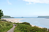 Elevated view of Padstow beach and coastal footpath at low tide, Cornwall, England, UK