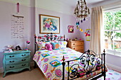 Colourful duvet and mobile in bedroom of Middlesex family home, London, England, UK