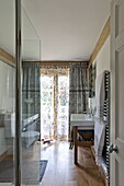 Glass shower screen and wash stand in bathroom of contemporary Suffolk/Essex home, England, UK