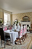 Upholstered dining chairs at table in Bury St Edmunds country home, Suffolk, England, UK