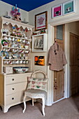 Chinaware in kitchen dresser at doorway in London home, England, UK