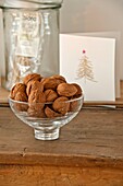 Walnuts in glass bowl with Christmas card in Wadebridge home, North Cornwall, UK