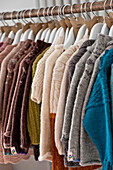 Assorted woollen jumpers on clothes rail Cornwall UK