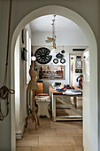 View through archway to table and bench in Stamford home Lincolnshire England UK