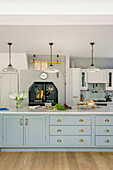 Light green fitted island unit in spacious Tunbridge Wells farmhouse style kitchen Kent England UK