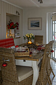 Wicker chairs at dining table at Christmas in Penzance farmhouse Cornwall UK
