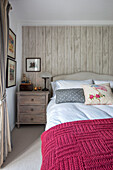 Vintage lamp and tealights on chest of drawers at bedside in Penzance farmhouse Cornwall UK