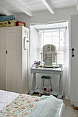 Dressing table and mirror in bedroom window of Marazion beach house Cornwall UK