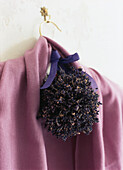 Pink cardigan on hander with ball made from dried lavender flowers
