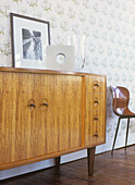 Cupboard with glass vases and picture