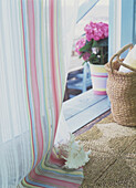 Basket pot flower and striped curtain