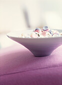Purple white and pink sweets in ceramic bowl