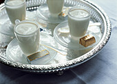 Desserts of syllabub and chocolates served on a silver tray for party food celebration
