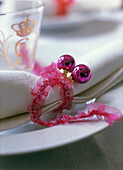 White napkins with pink bauble and ribbon