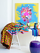 Assorted fabrics with modern art and purple stool