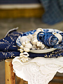 Seashells and string in bowl on fabric Spain