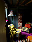 Chairs covered in tartan fabric in beamed farmhouse