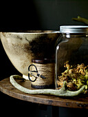Dried courgette flowers with ceramic bowl and spool of string with scissors