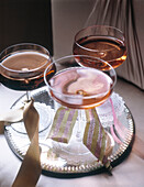 Three glasses of pink champagne tied with ribbon