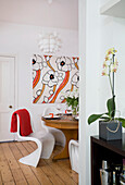 Dining table and orange canvas in Manchester family home, England, UK