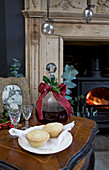 Mince pies and decanter with bow on side table in living room of Tenterden family home, Kent, England, UK