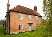 Exterior of detached brick High Halden farmhouse Kent England UK