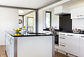 Lemons in bowl on kitchen island with sink in Rolvenden water tower conversion Cranbrook Kent England UK