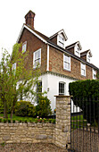 Stone gatepost at exterior of three-storey semi-detached Kilndown home Cranbrook Kent England UK